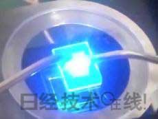   發光試驗中的LED元件。基板尺寸：1cm見方，元件尺寸：0.3mm見方，注入電流：約200mA，中心波長：450nm 